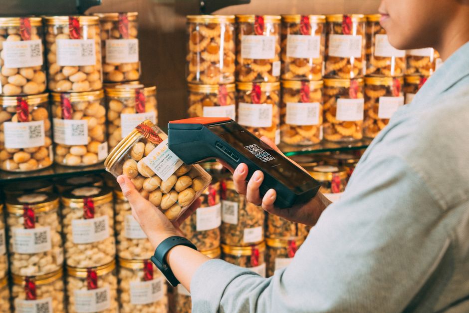 A shopper scanning a CBD bottle's QR code to pull up its lab report