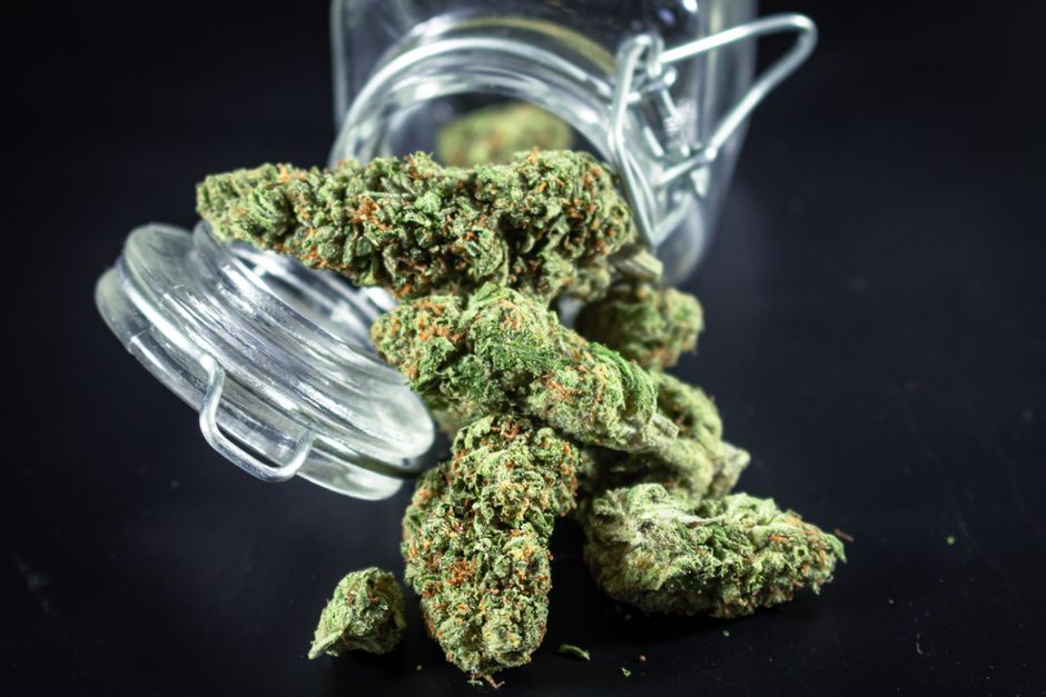 A dispensary menu wall covered in flashy strain names